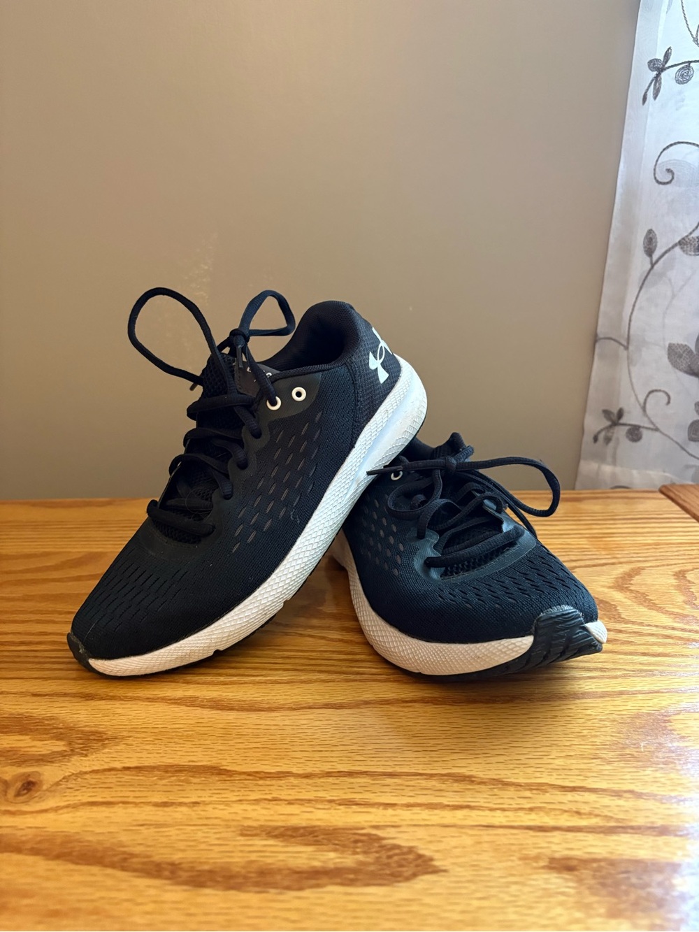 Women’s Under Armour Charged Pursuit black sneakers